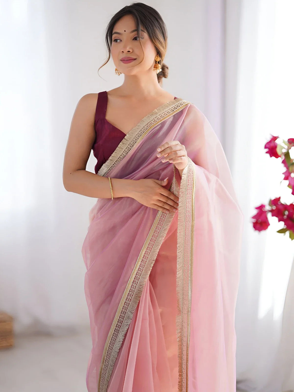Tarani lightweight pink net saree with sequin lace paired with maroon blouse