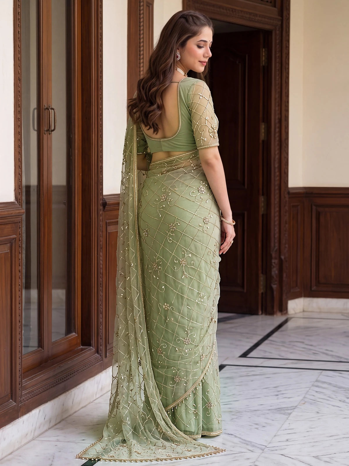 Tarani sage green net saree back view showcasing blouse back design and pallu