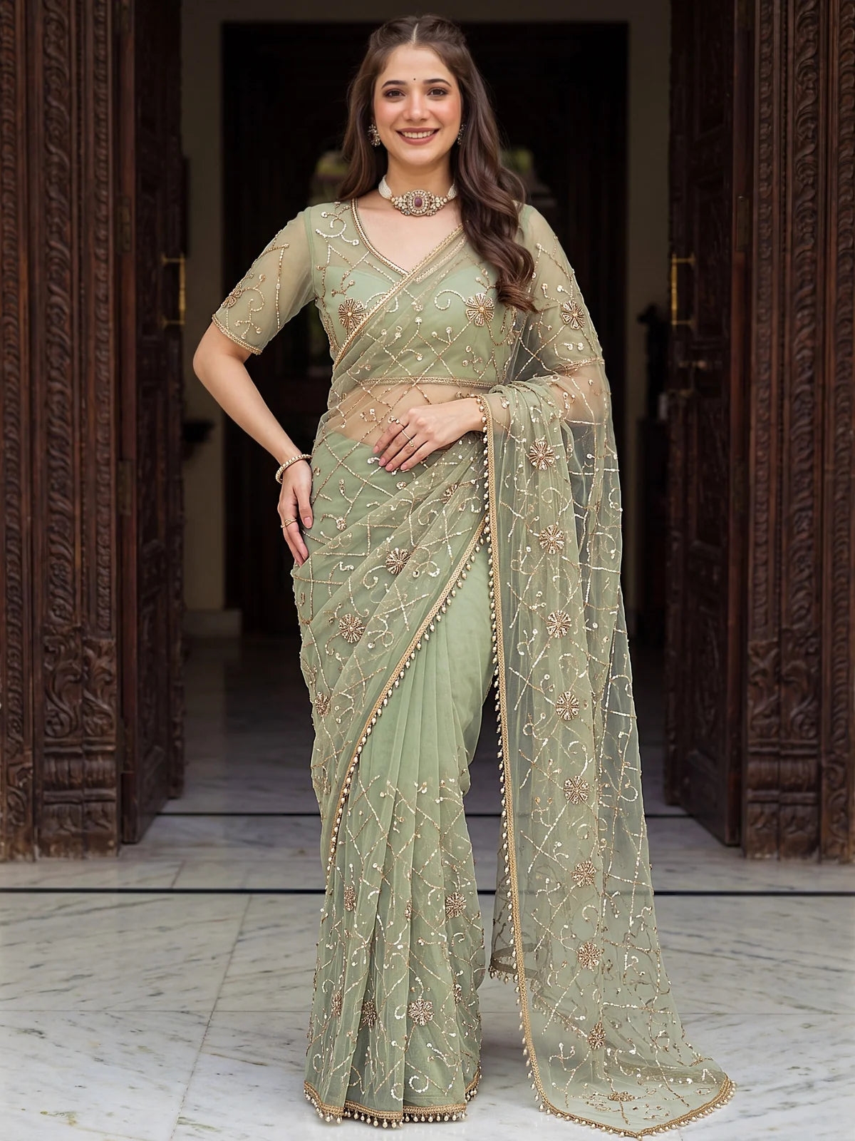 Tarani sage green net saree front view with elegant drape and pearl embroidery