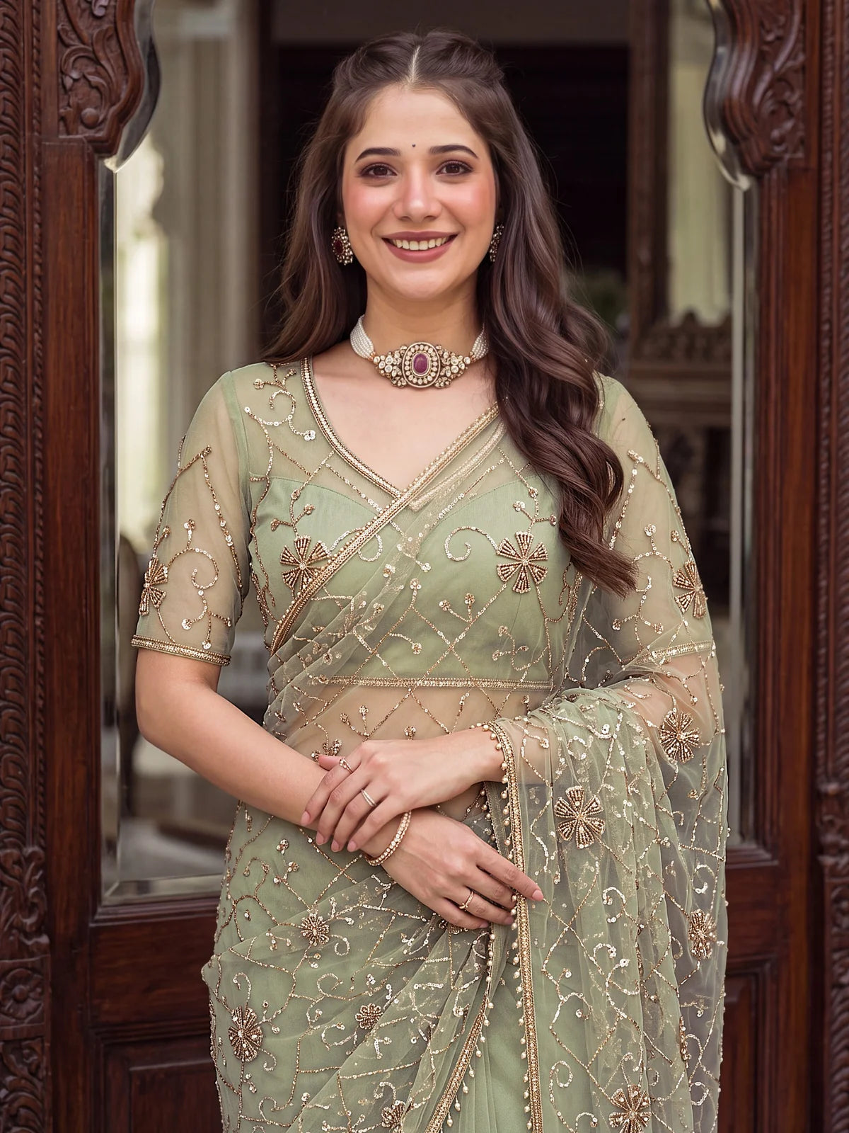 Tarani sage green net saree upper body view showing embroidered blouse and neckline