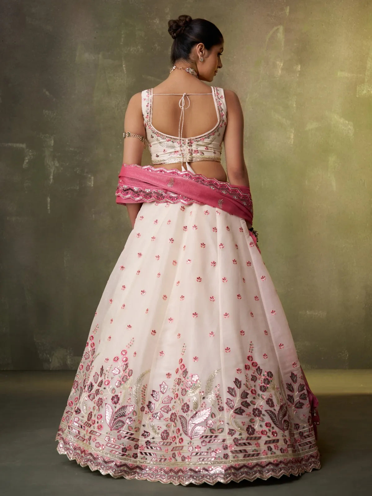 Tarani cream organza lehenga back pose highlighting blouse design and dupatta drape