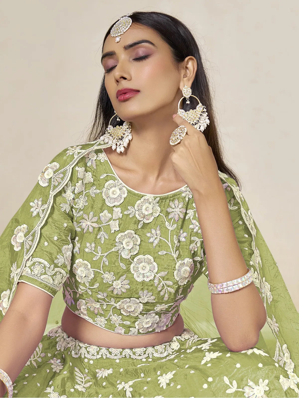 Tarani elegant green organza lehenga upper body view showing blouse embroidery and dupatta drape