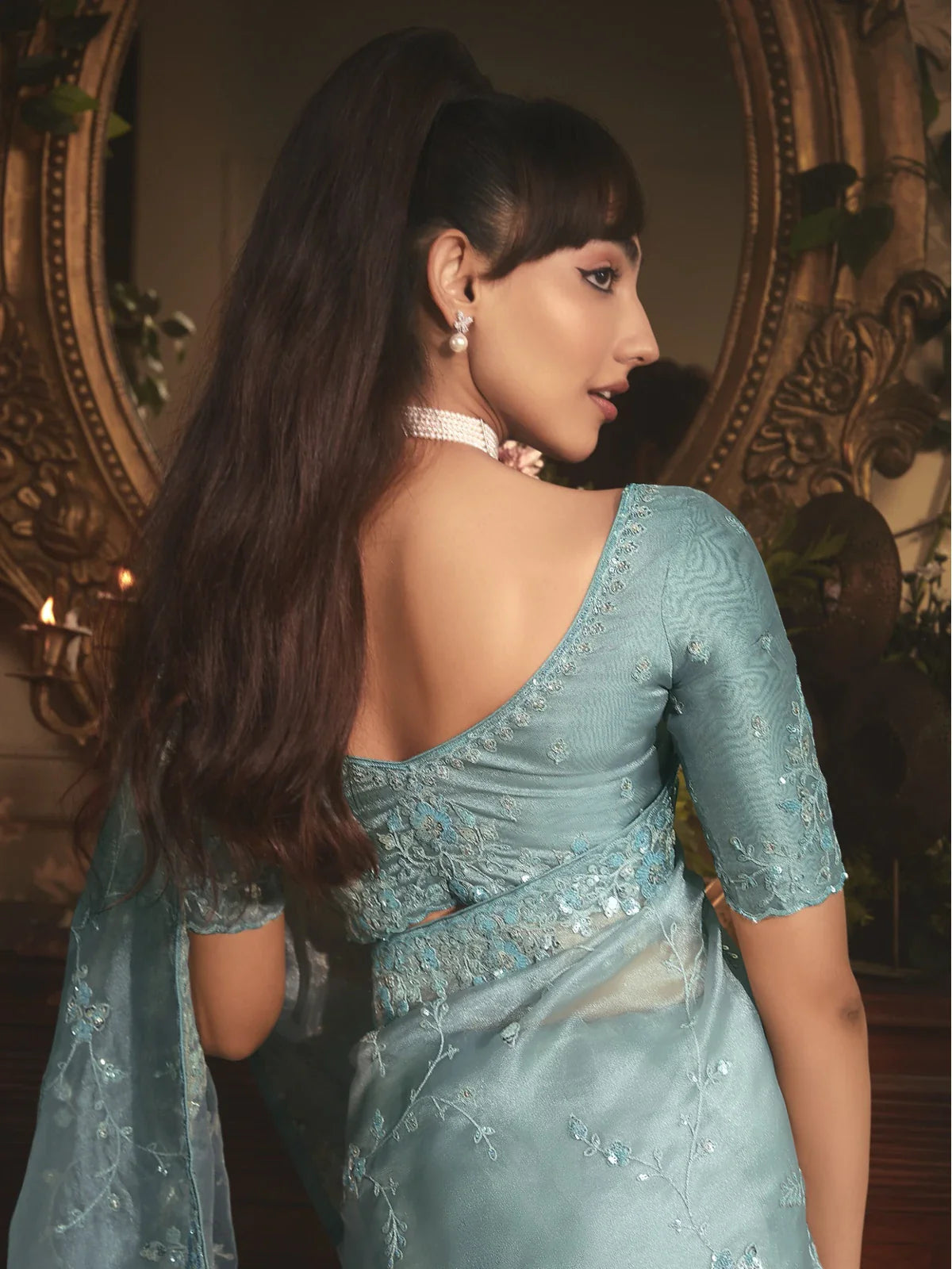 Tarani organza saree in blue with embroidered blouse and heavy work back view