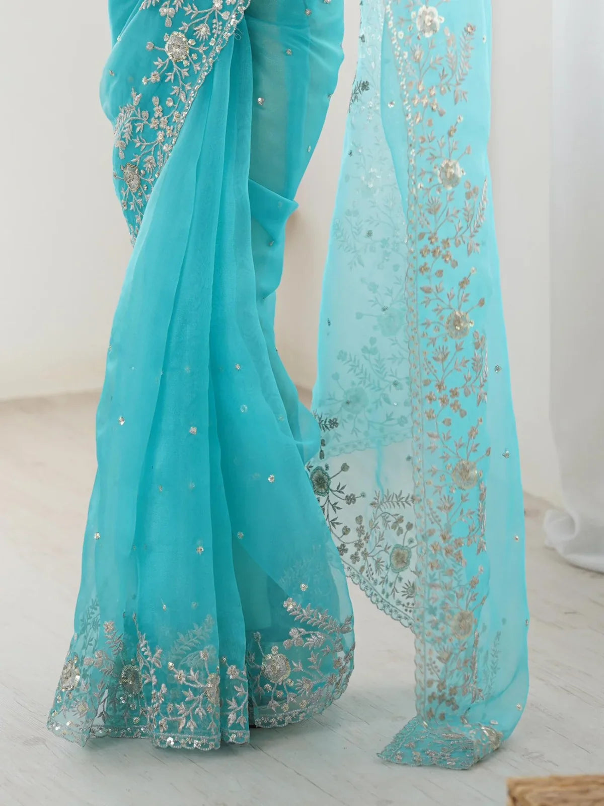 Closeup view of Tarani blue organza saree with thread and sequin work