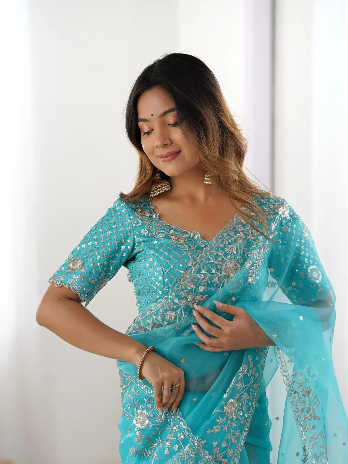 Tarani organza saree upper body view showing sequin embroidery and designer blouse