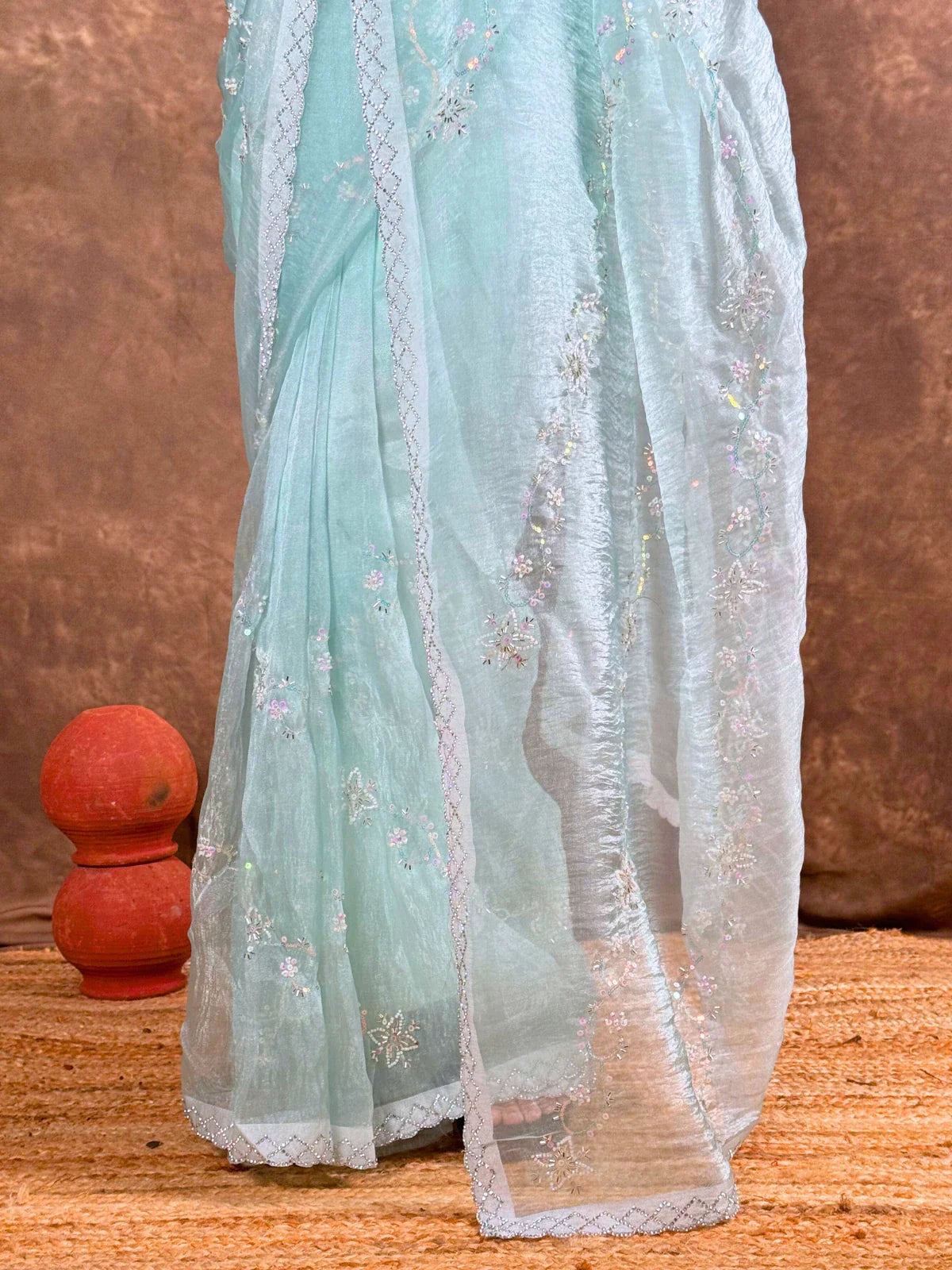 Tarani sequin and cutdana embroidery closeup on light blue organza saree fabric detailing
