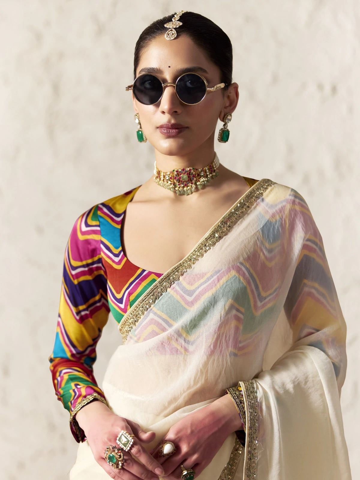 Tarani off white fancy fabric saree upper body view with sequins embroidery and colourful designer blouse