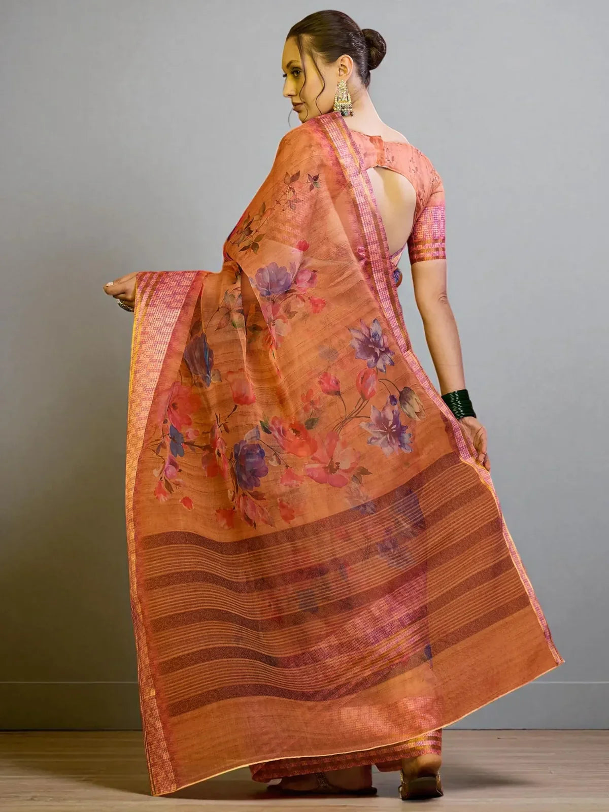 Tarani orange saree back view with floral design and elegant pallu drape