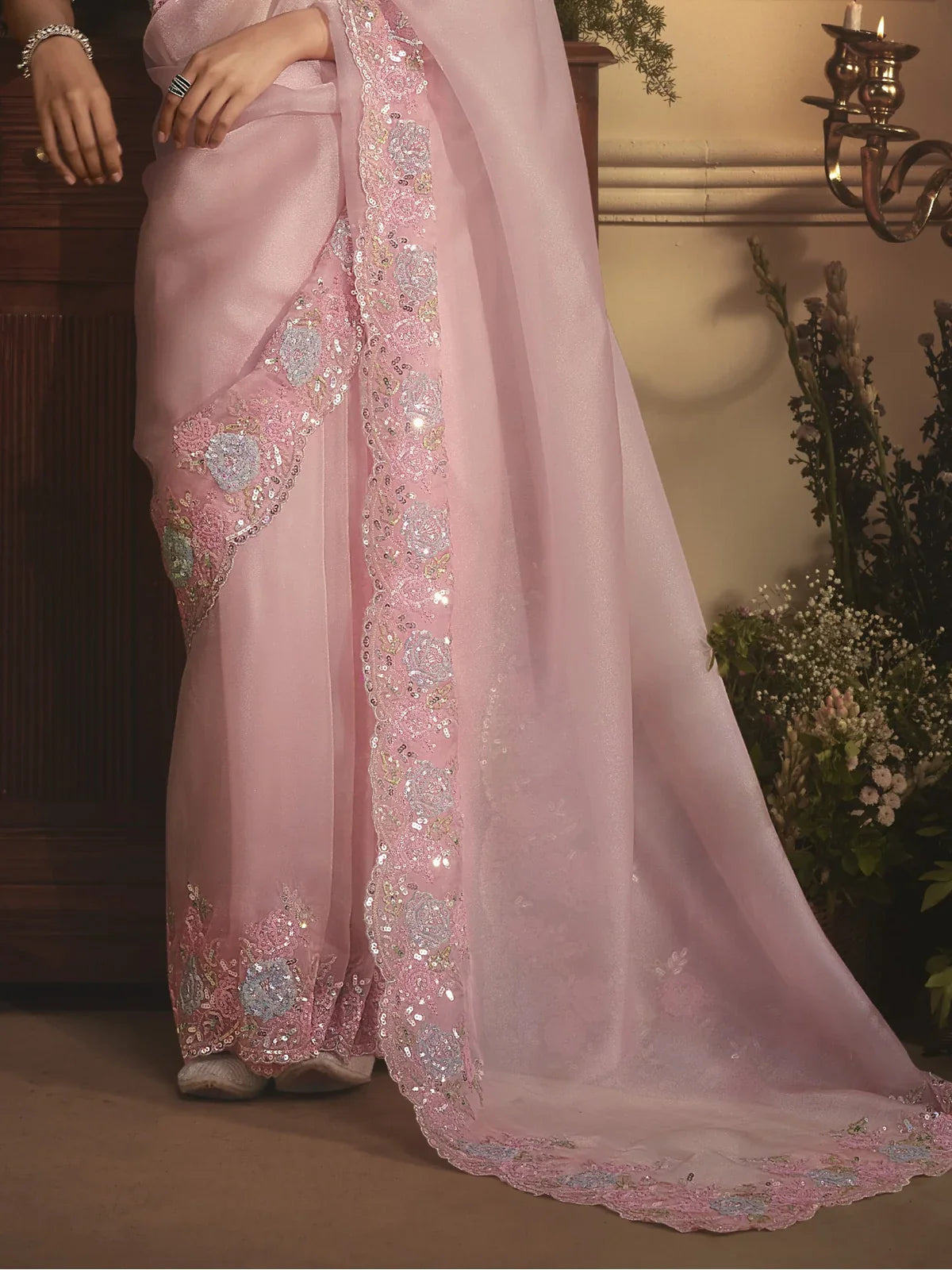 Tarani pink organza saree pallu view with shimmering embroidery and floral motifs