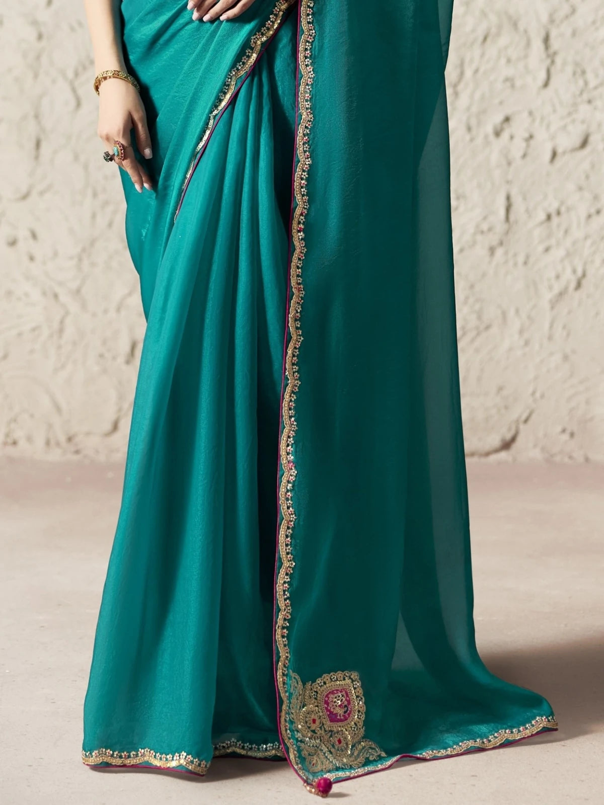 Tarani teal organza saree pallu and border closeup with detailed embroidery lace work