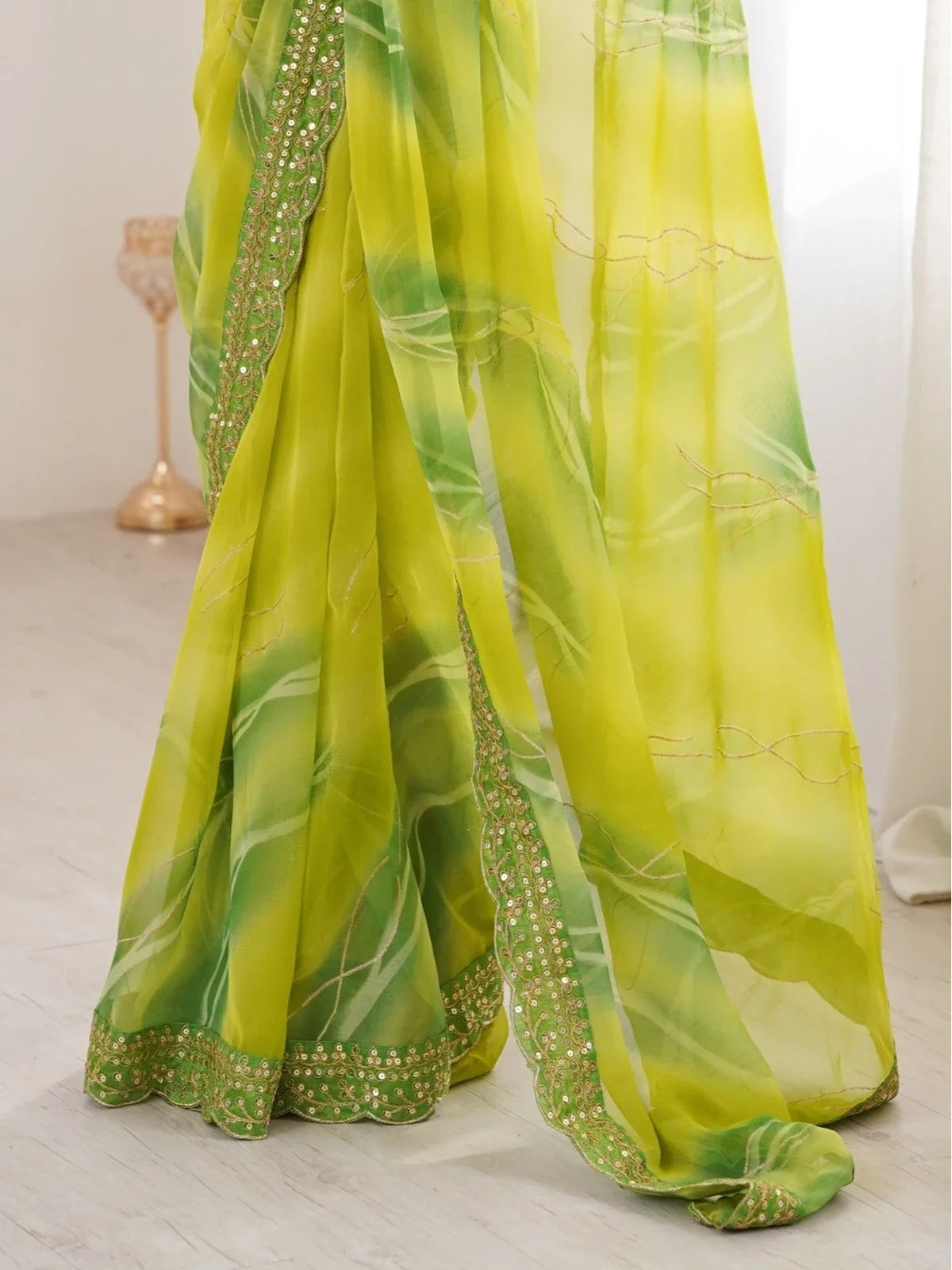Tarani green saree pallu view showing foil work and elegant flow