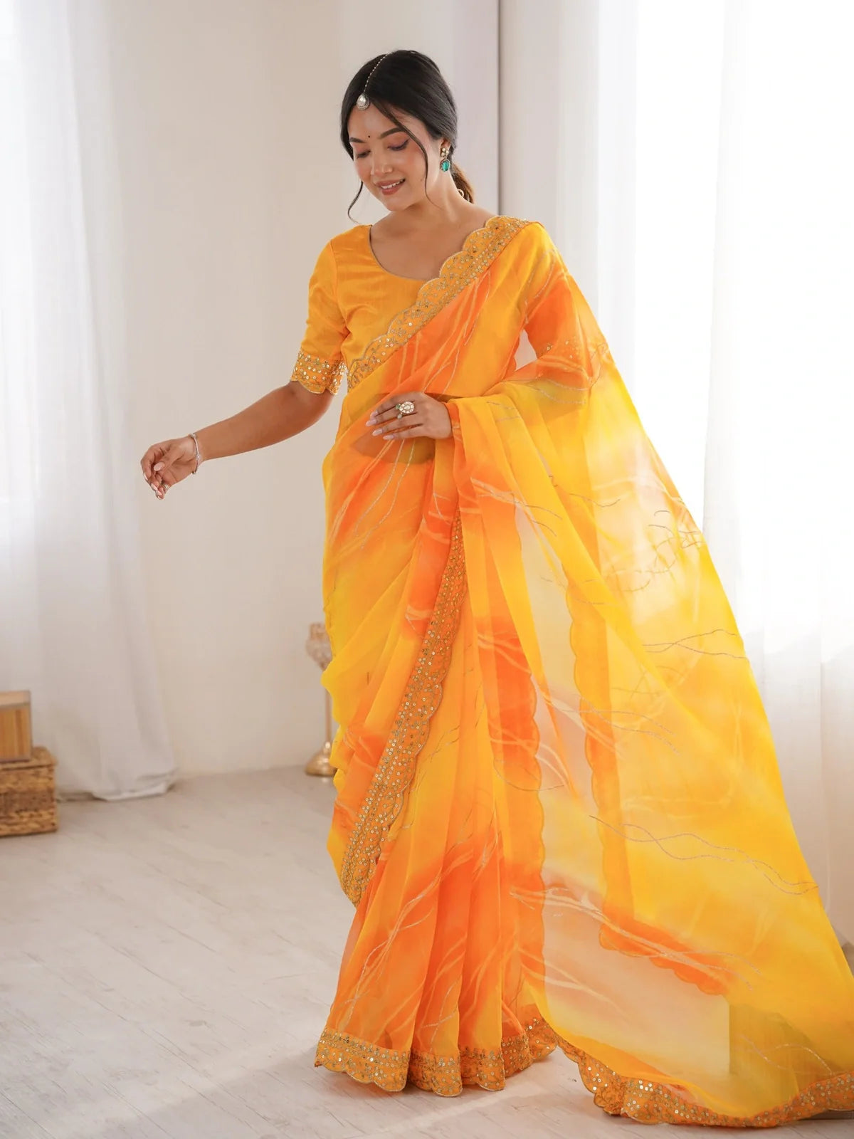 Tarani yellow georgette chiffon saree with golden foil work and festive border front view