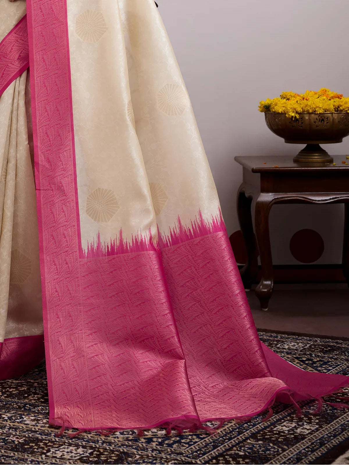 Tarani premium beige saree with pink border close-up showing woven detailing and texture