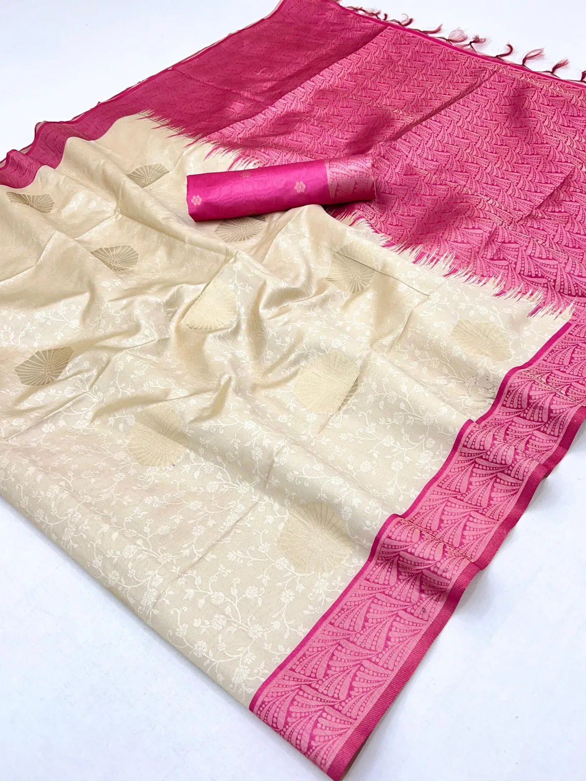 Pallu view of beige paper silk saree with detailed pink border from Tarani