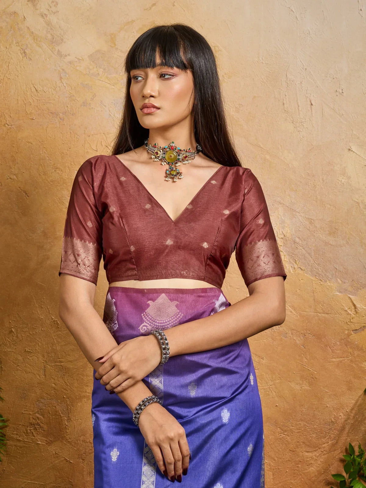 Tarani blue purple paper silk saree styled with deep maroon blouse in upper body view