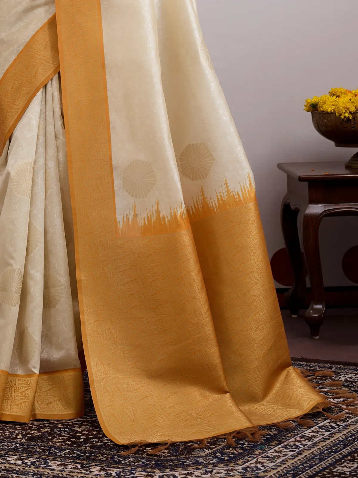 Tarani close-up of cream handloom paper silk saree with soft woven motifs and golden border