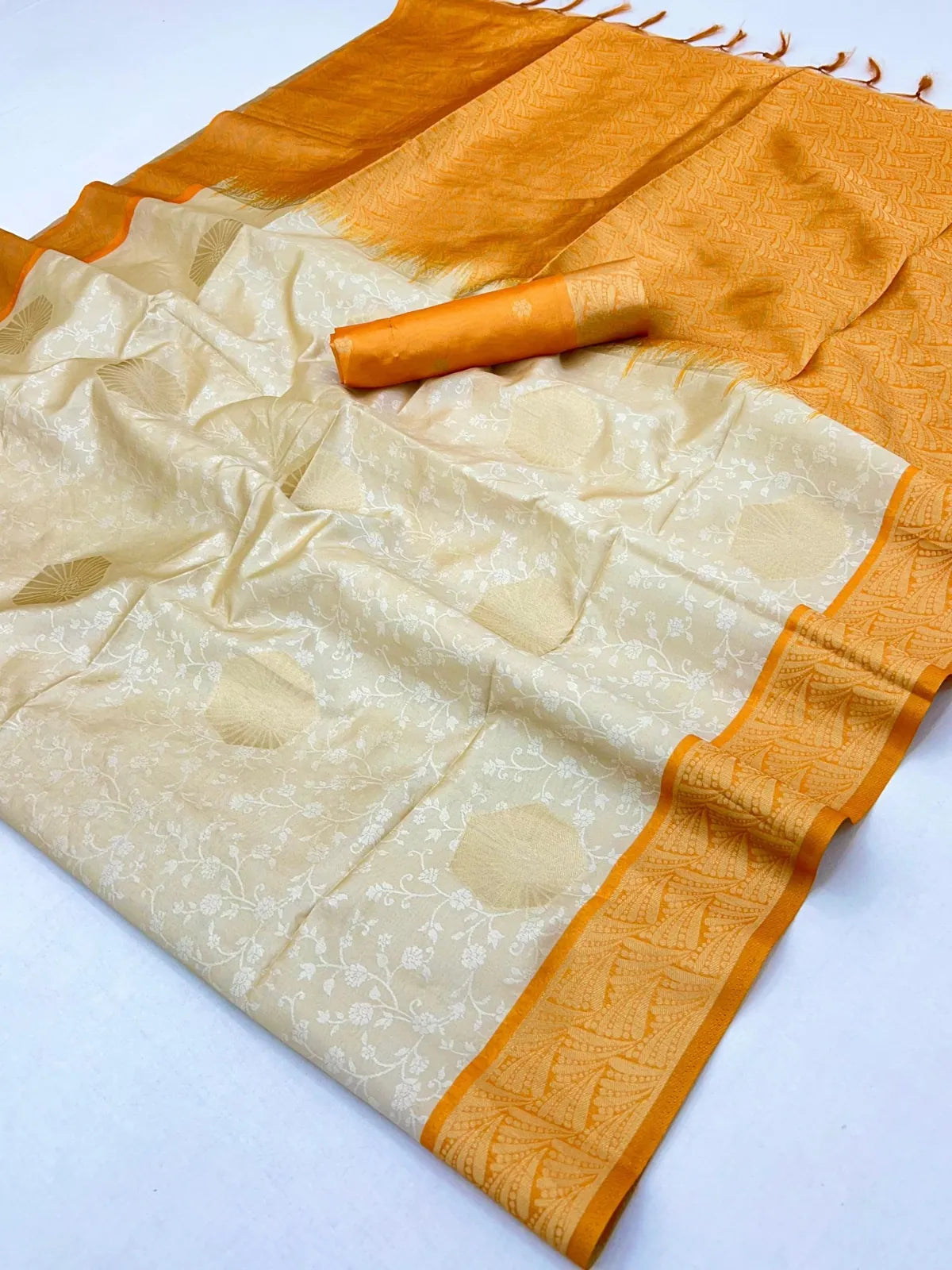 Tarani pallu view showcasing intricate golden weave on cream saree with tassel detailing