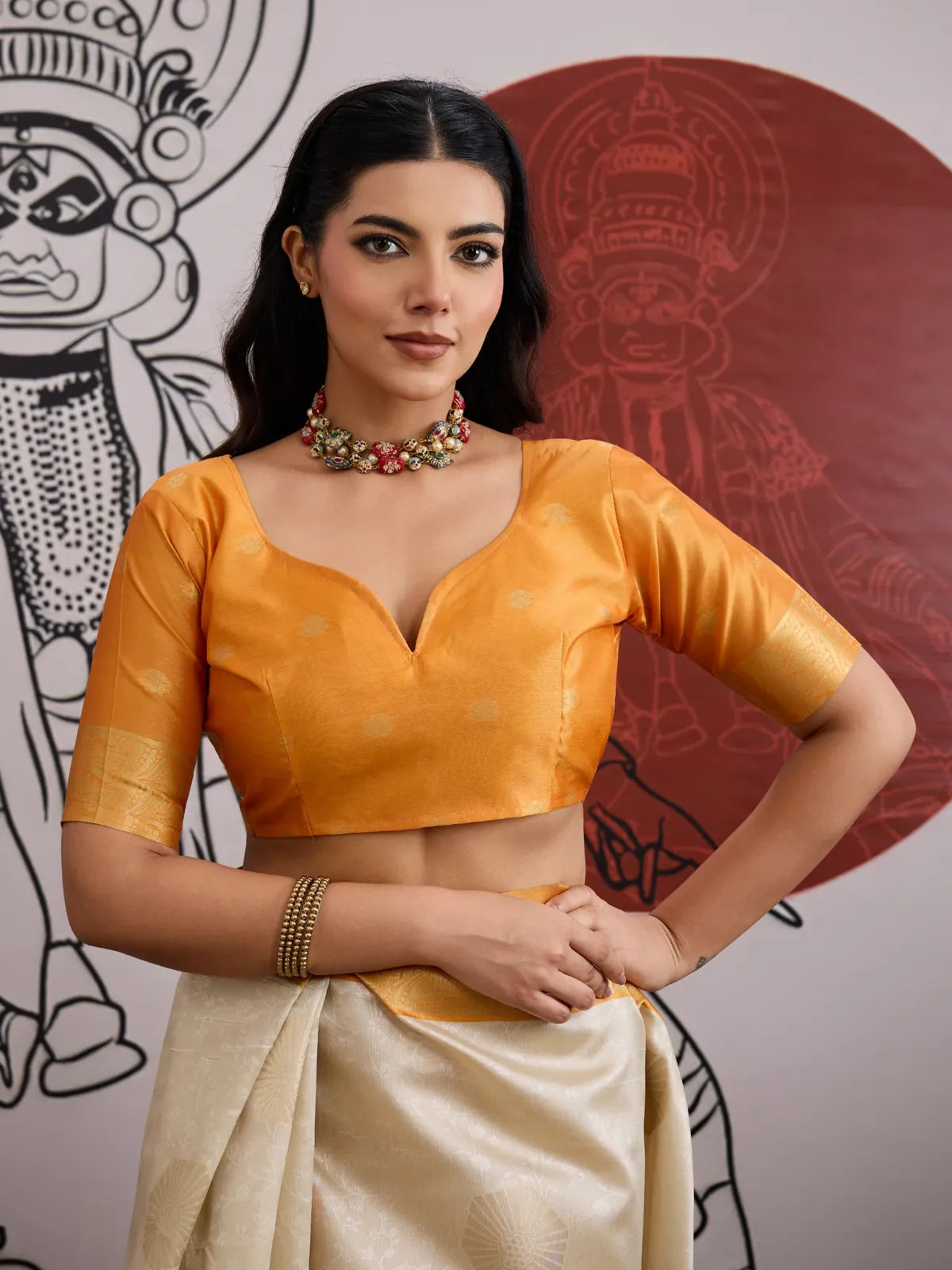 Tarani cream saree upper body view with golden sleeve blouse and statement necklace
