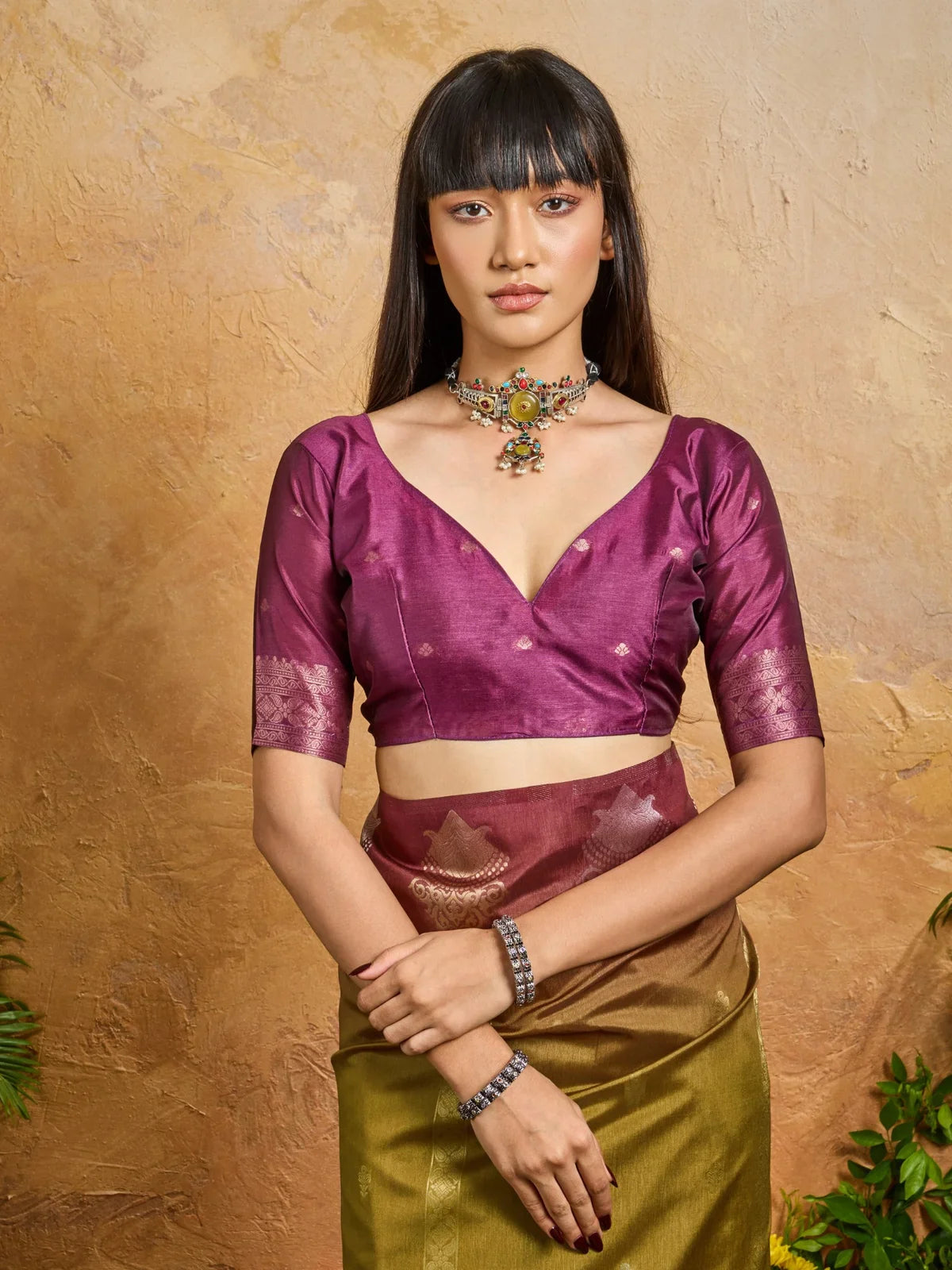 Tarani elegant green saree styled with magenta blouse and antique choker set for festive look