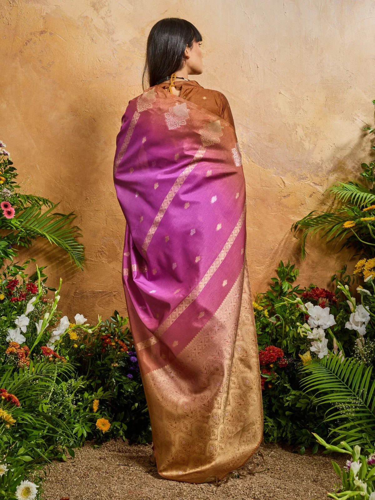 Tarani back view of purple paper silk saree with rust blouse and golden zari detailing