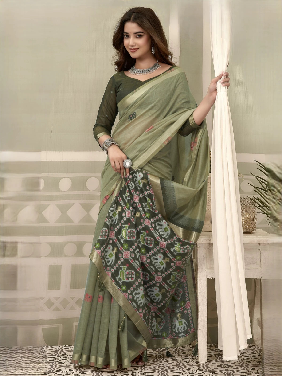 Tarani green patola saree with zari border and fancy tassels front-view