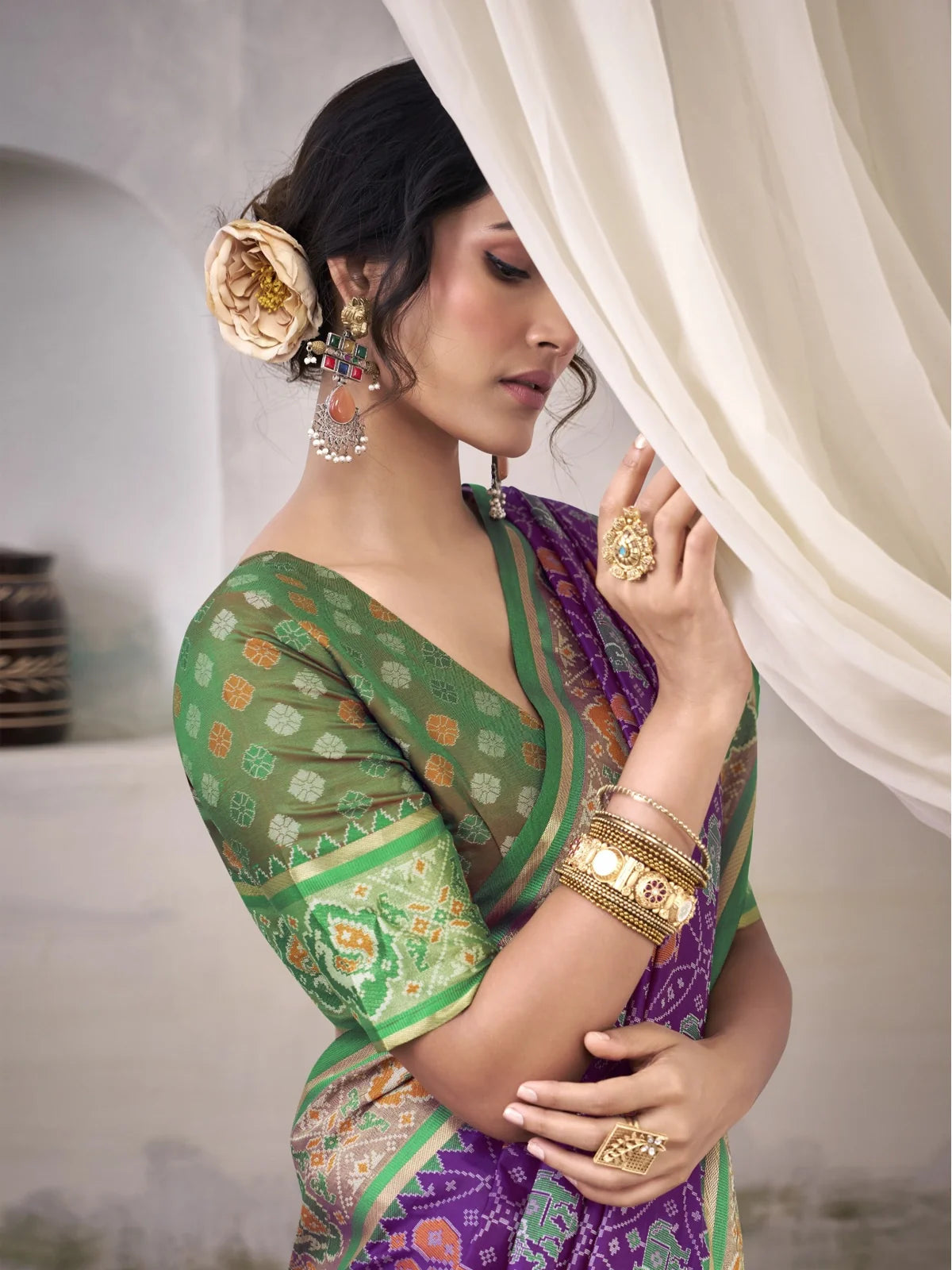 Tarani Patola silk saree upper body view with green blouse and purple drape