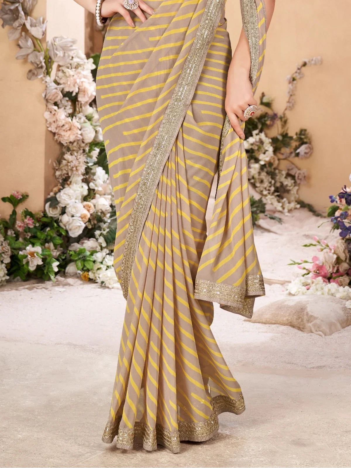 Tarani beige yellow leheriya saree pallu and border view with festive detailing