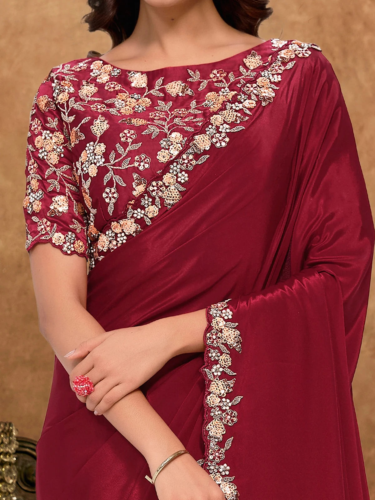 Tarani Jinala closeup view of sequence and moti embroidery detailing on maroon saree