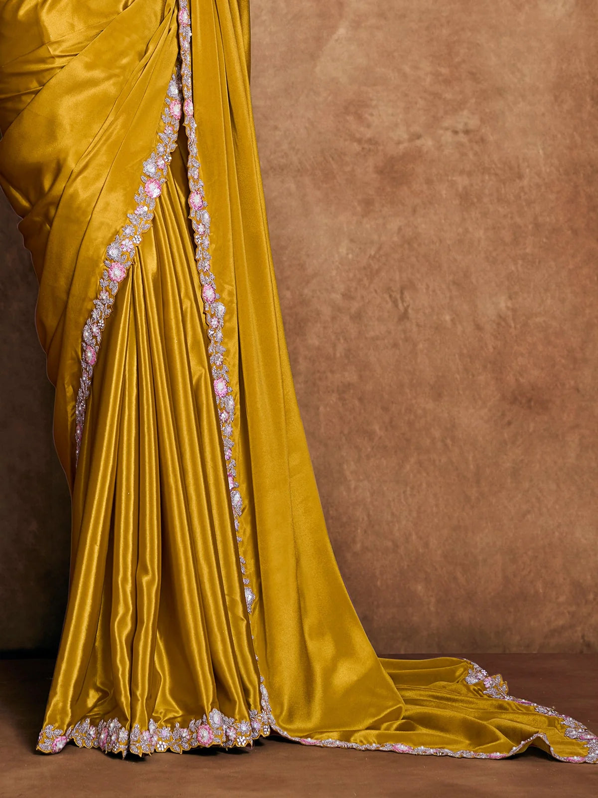 Tarani Samidha pallu view of mustard Pure Crepe Satin saree with floral embroidered border