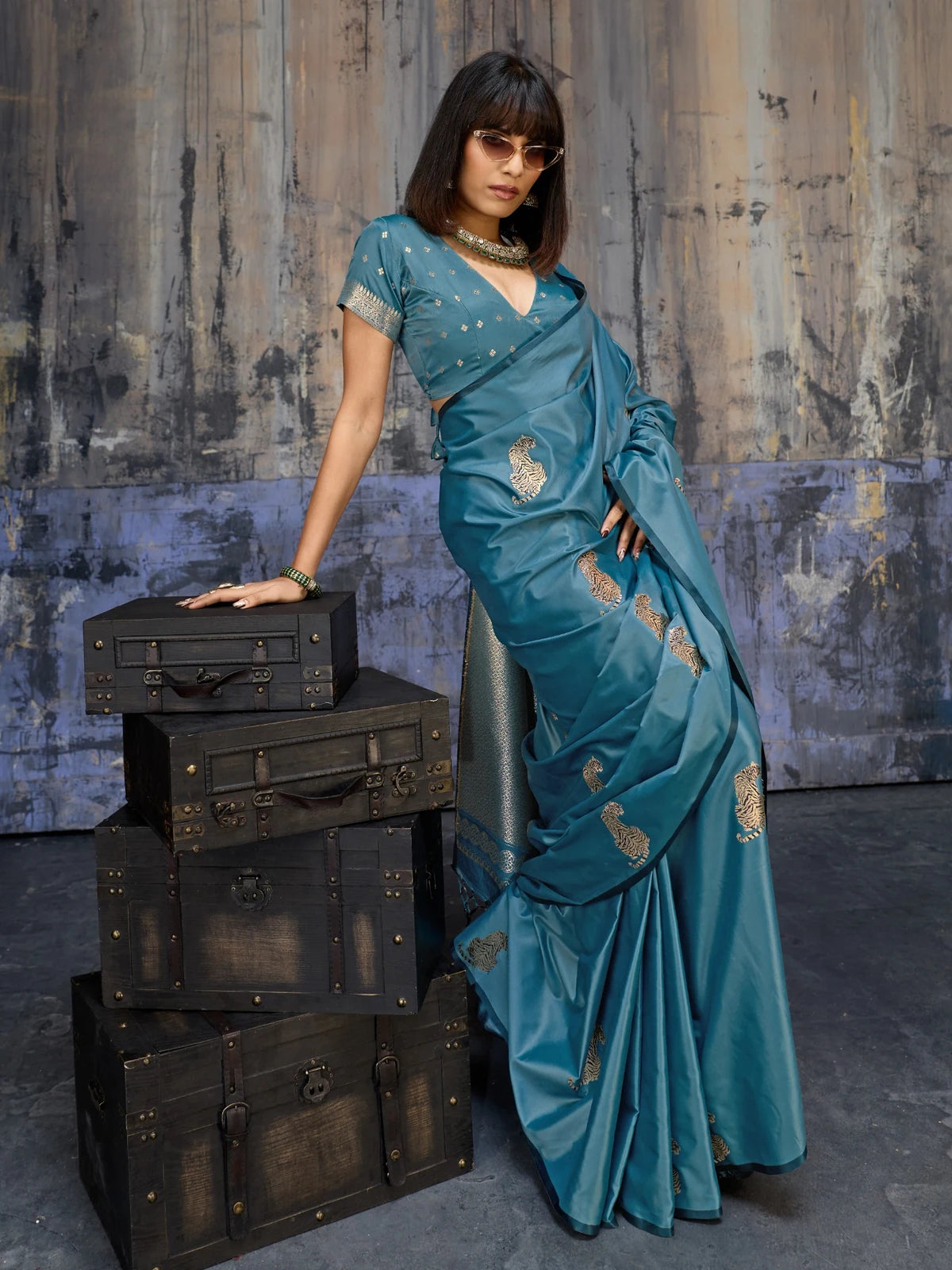Tarani teal pure satin saree side pose with elegant woven border and designer drape