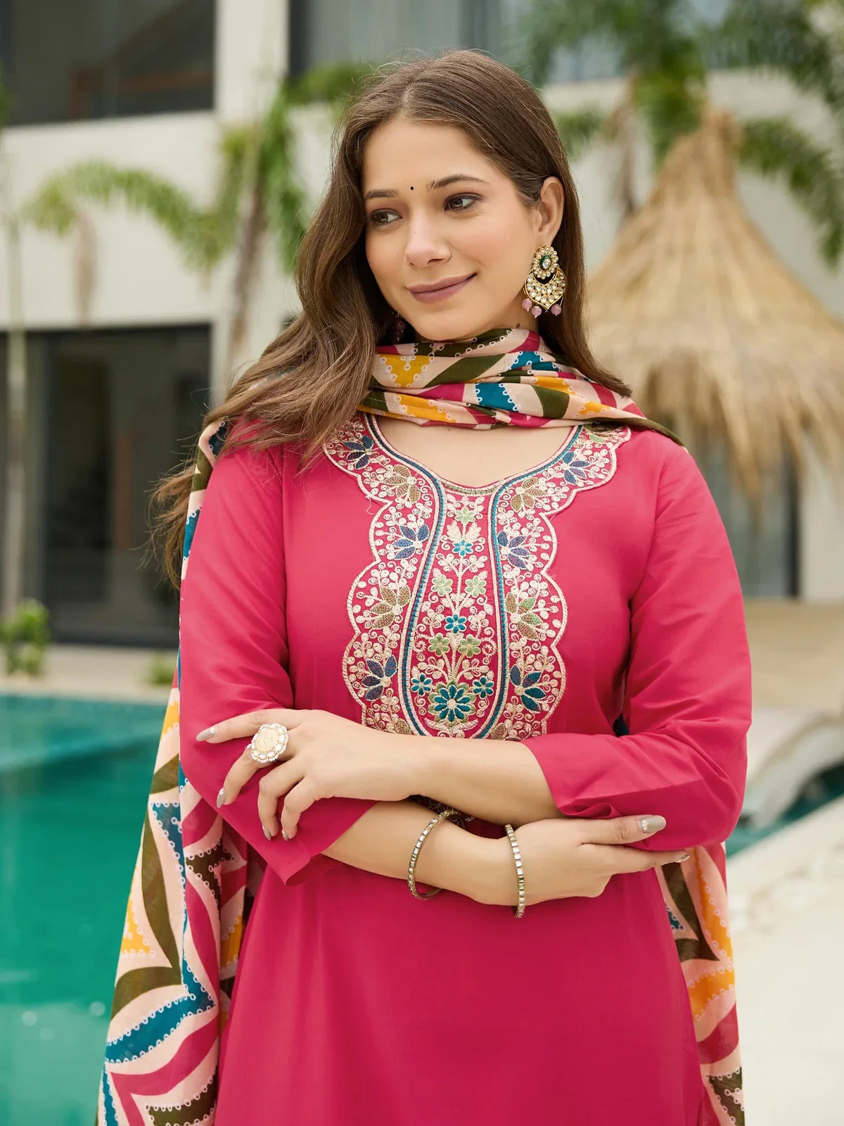 Tarani upper body view of rayon dress showing intricate neckline embroidery and earrings styling