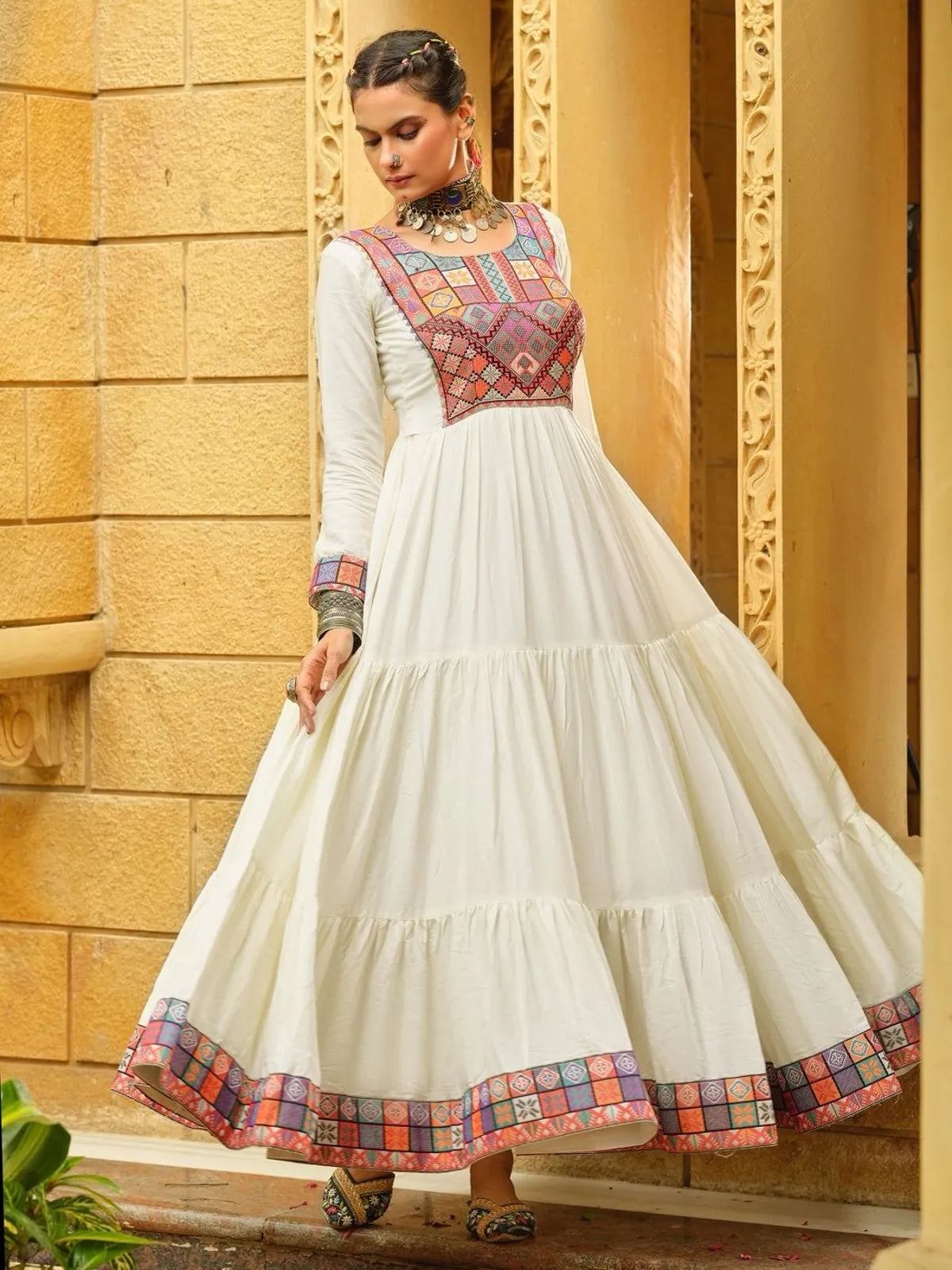 Tarani elegant white rayon gown with traditional work and flair, shown from front angle