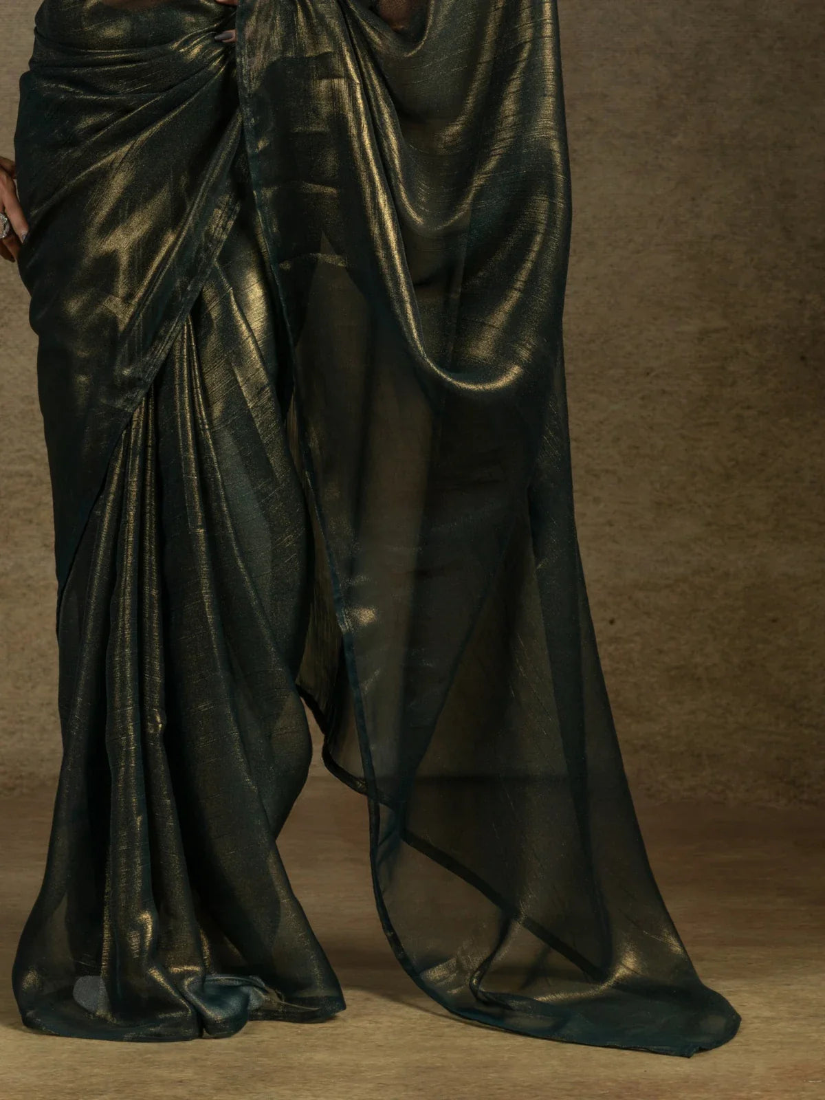 Tarani green satin chiffon saree pallu view with flowy sheer fabric and golden shine