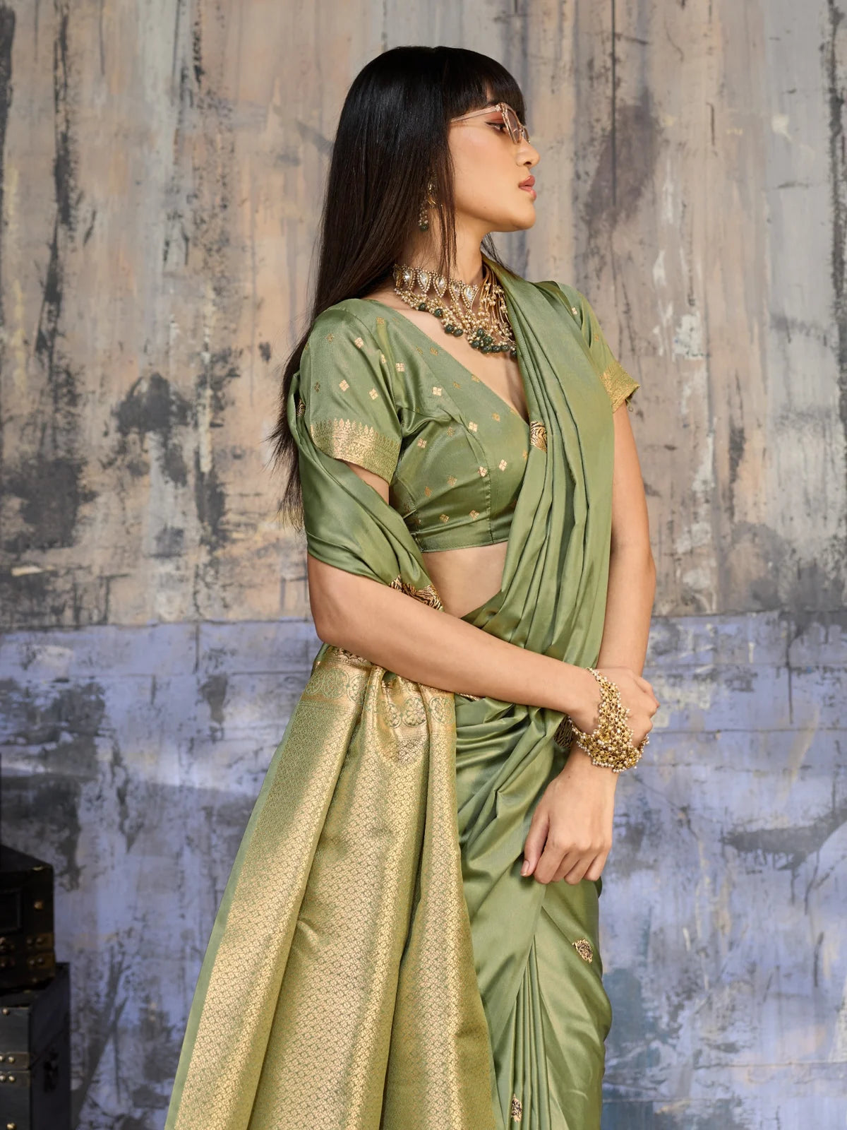 Tarani olive green satin handloom saree side view with rich zari pallu and elegant drape