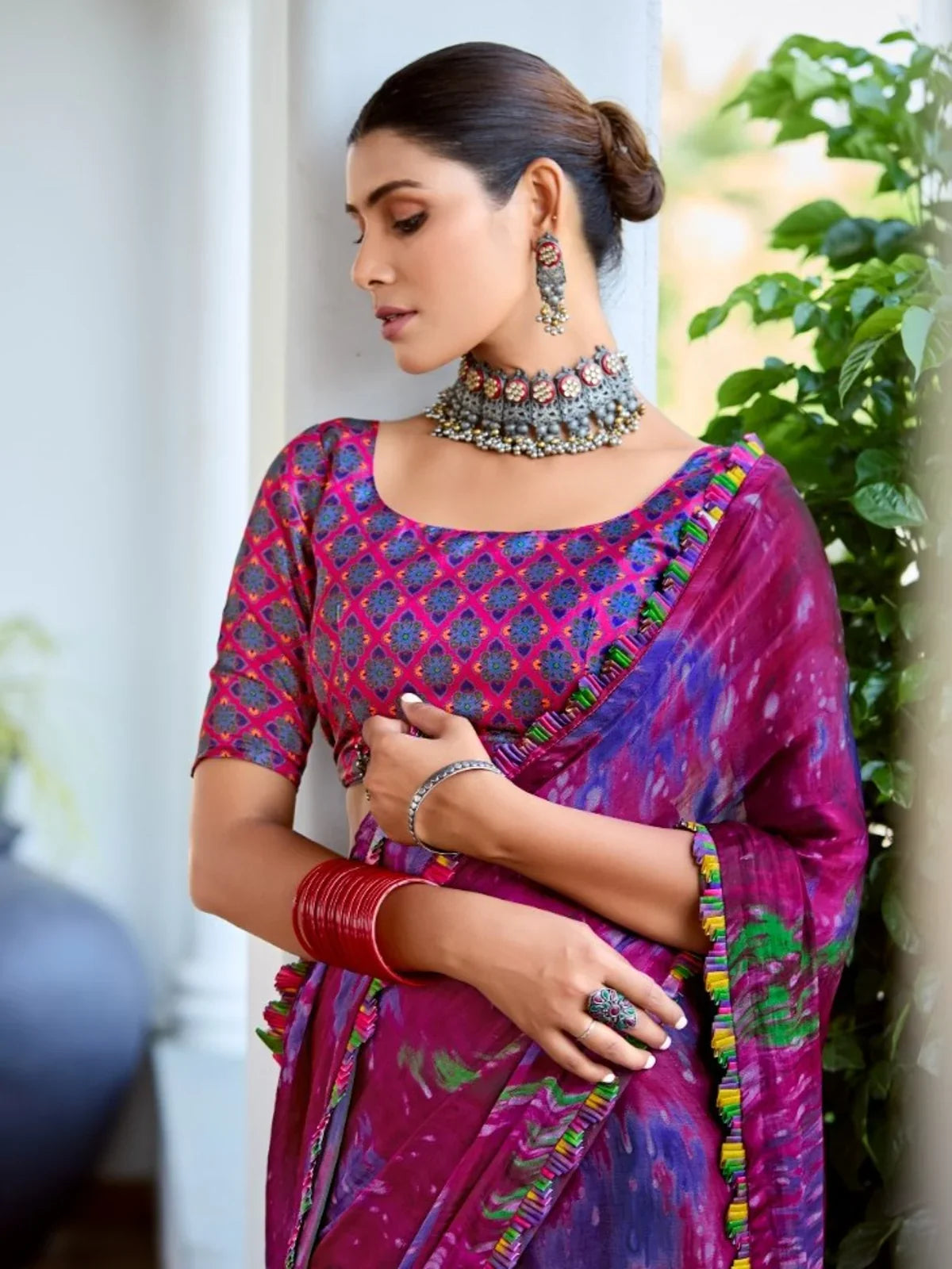 Tarani premium satin saree upper body view with elegant jewellery and rich magenta hue