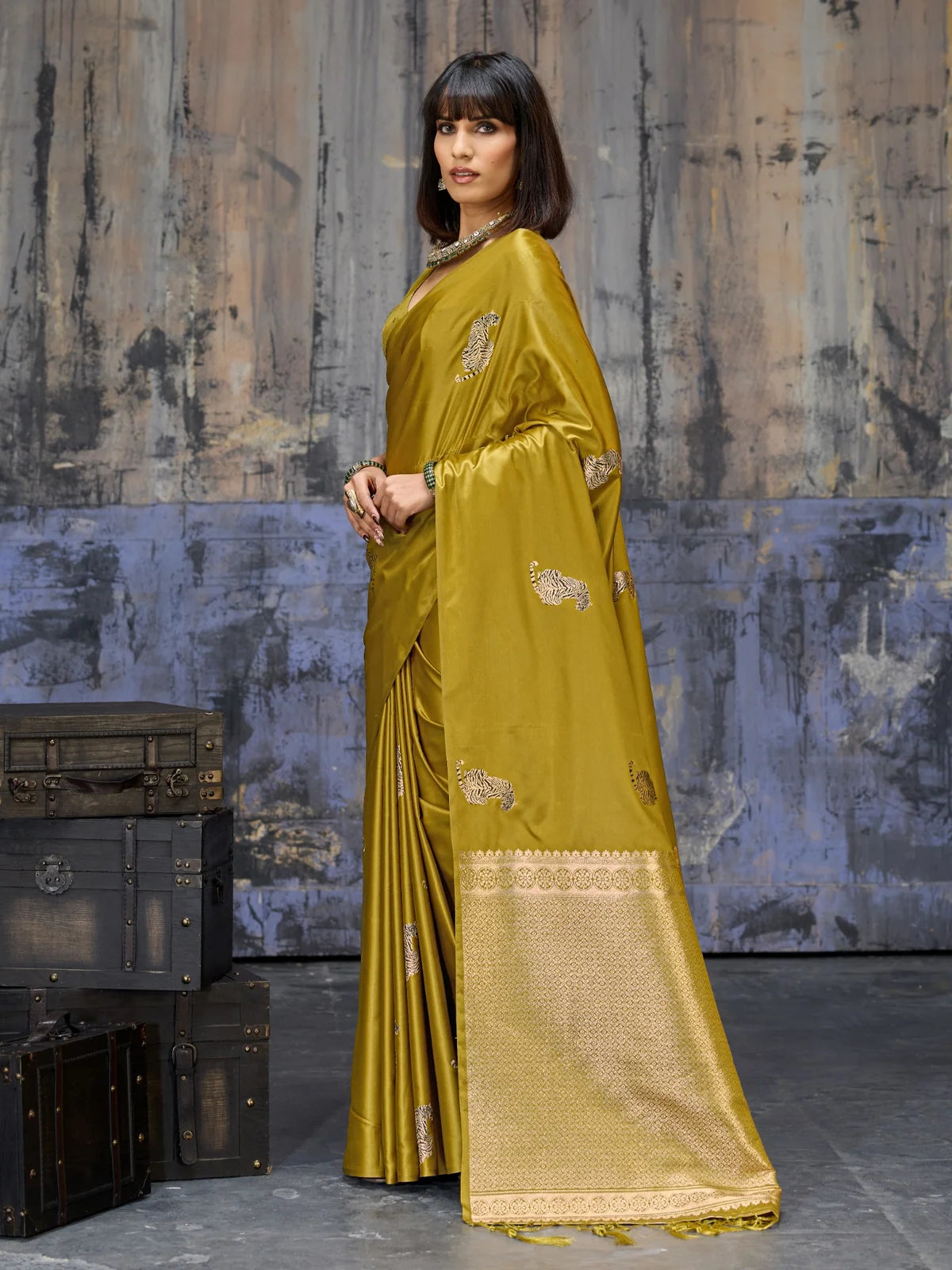 Tarani mustard satin saree pallu view with tassels and detailed woven border