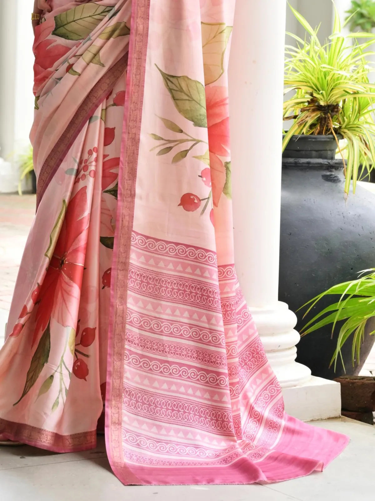 Tarani satin saree close-up showing soft pink fabric with floral print and zari border
