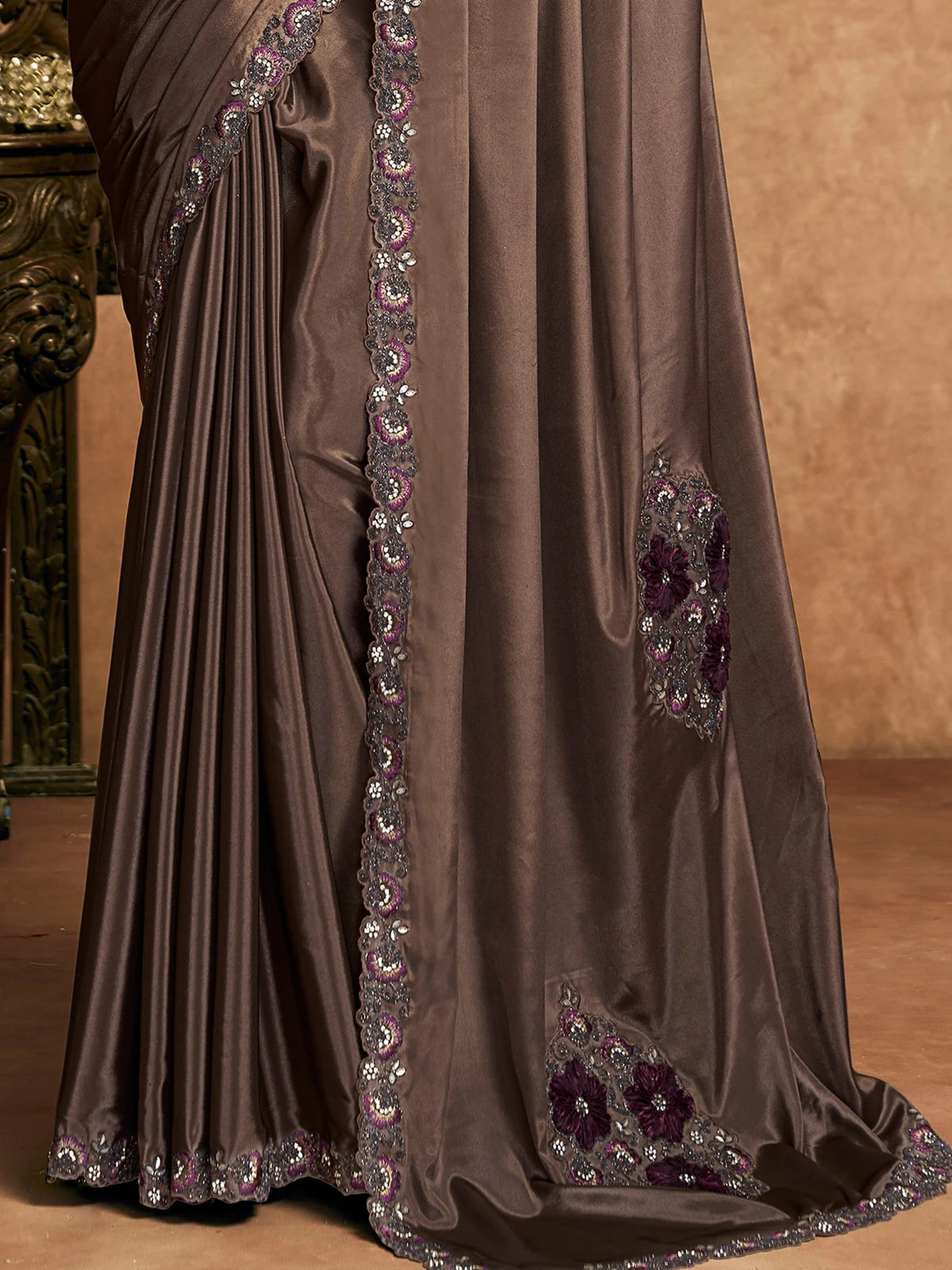 Tarani Harshita pallu view of brown lustrous satin silk saree with embellished floral border