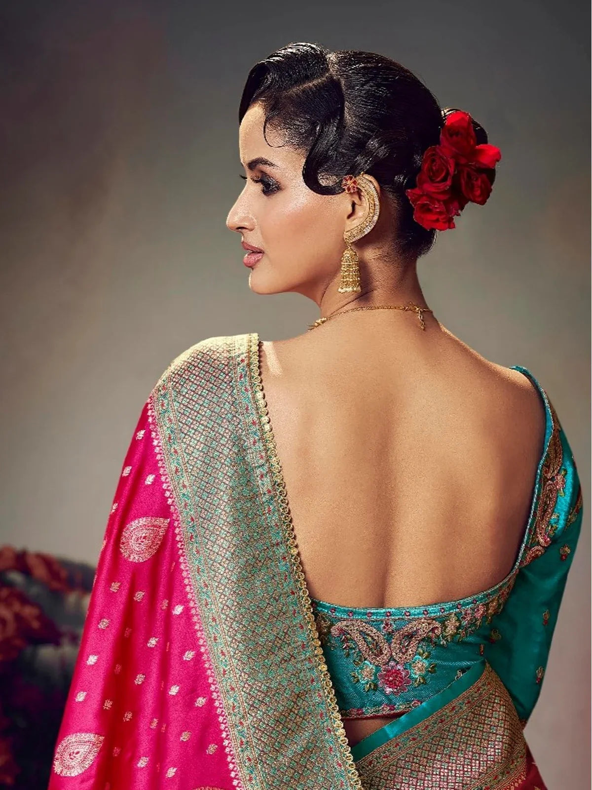 Tarani satin silk saree back view highlighting embroidered turquoise blouse and drape details