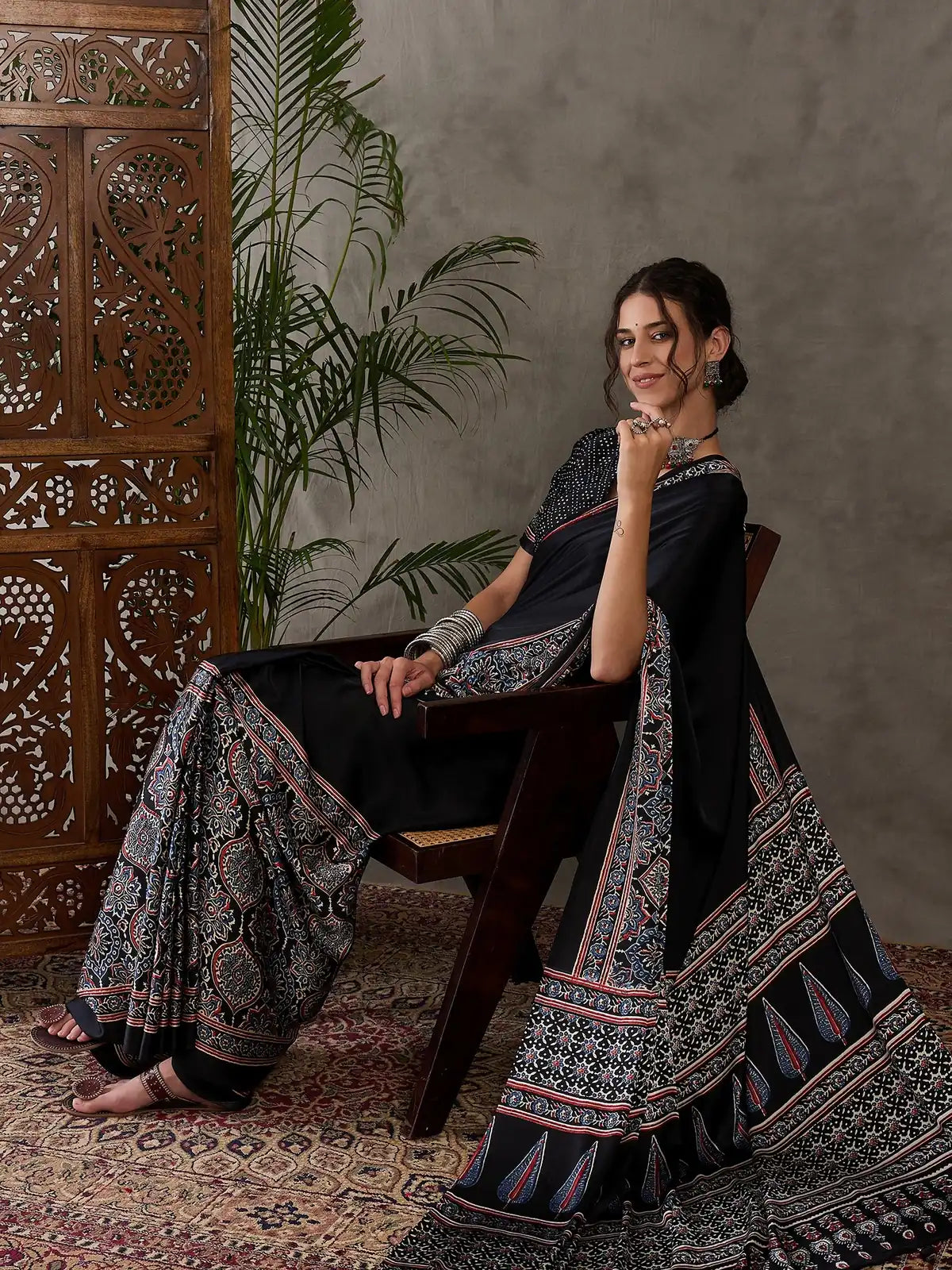 Tarani black semi modal satin saree side view displaying pallu and border