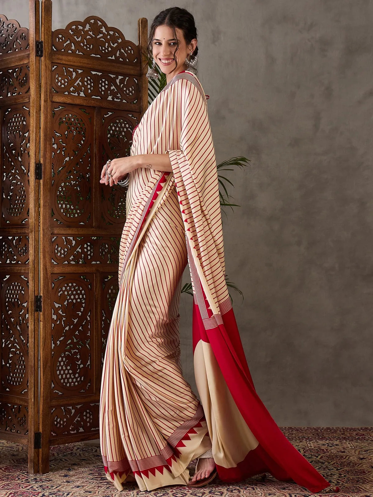 Tarani Malini cream printed saree side pose with flowing pallu