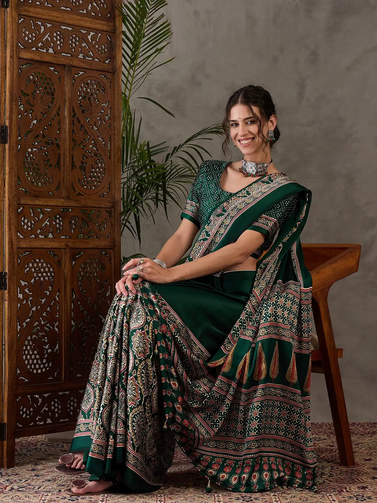 Tarani green semi modal satin saree seated front view with traditional print details