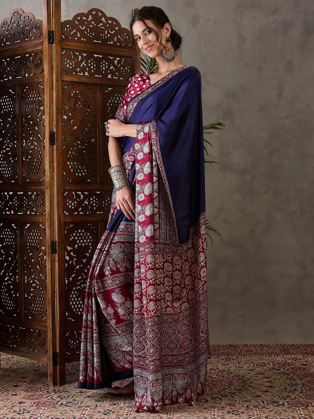 Tarani Ishaniya navy blue semi modal satin saree side pose highlighting elegant drape