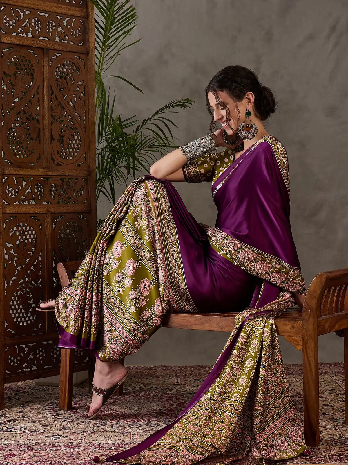 Tarani purple party wear saree side pose highlighting elegant drape