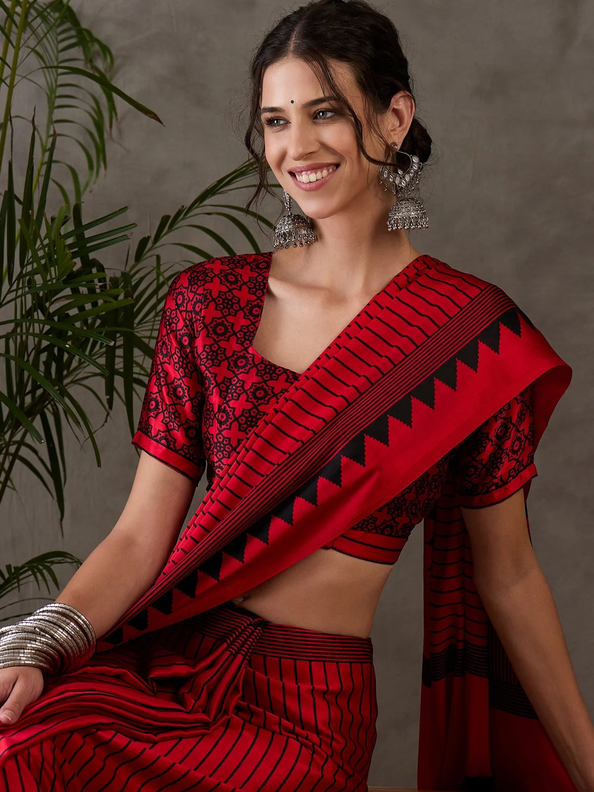 Tarani red semi modal satin saree closeup showcasing printed blouse and border details