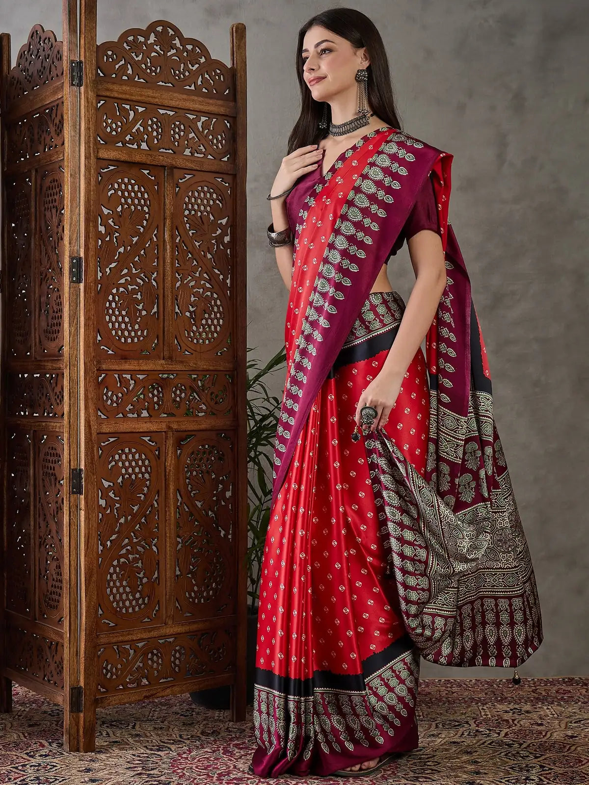 Tarani Aruna red printed saree elegant side pose for party and festive wear