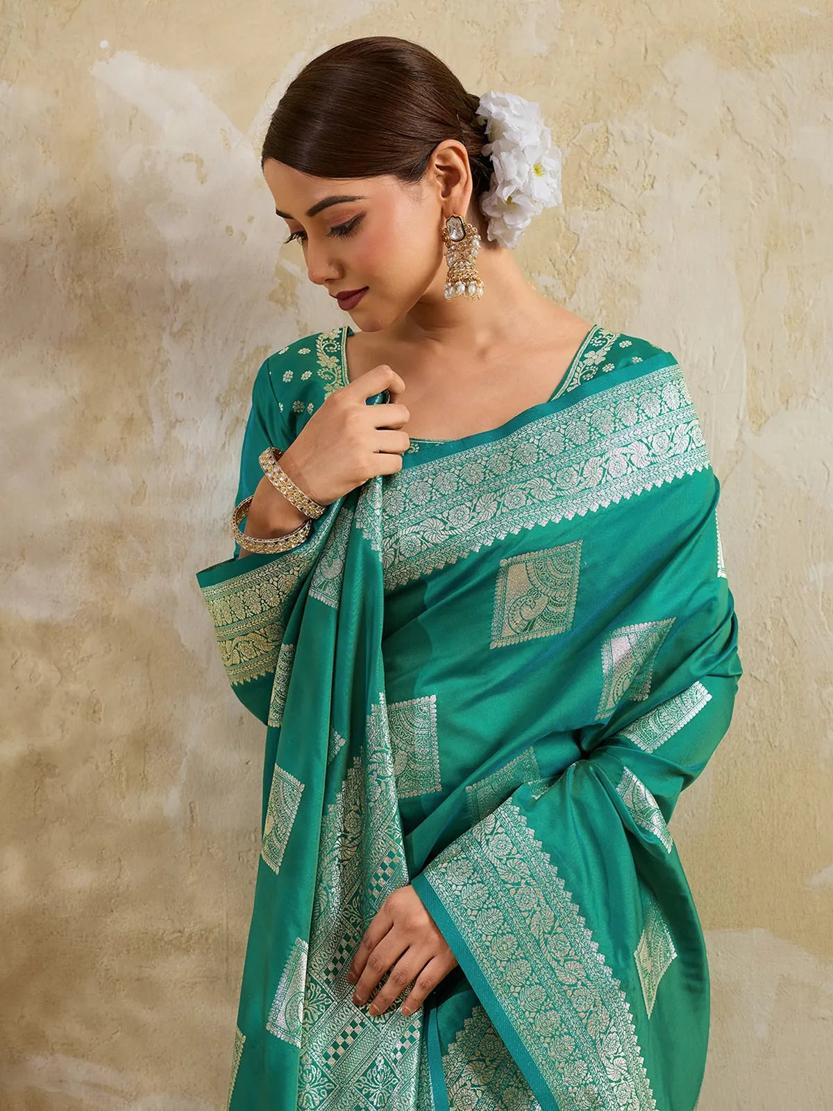 Tarani closeup view of green silk blend saree with zari woven motifs and rich border