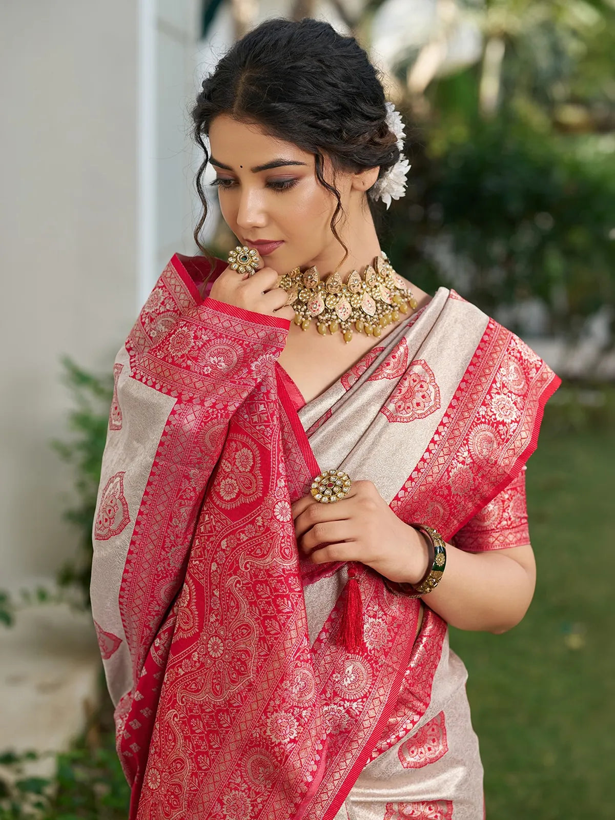 Tarani Shravya red silk blend saree pallu view highlighting intricate woven border and tassels