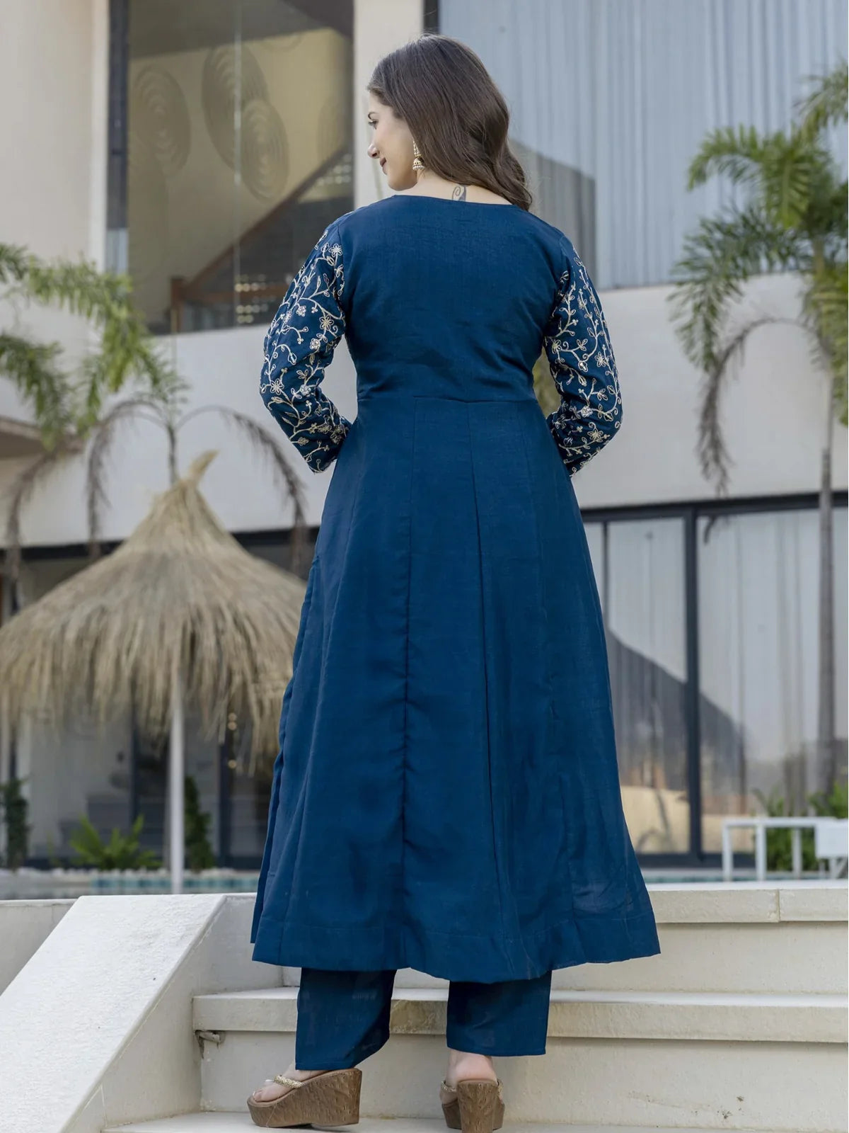 Tarani blue silk dress back view showing embroidery on sleeves and flowy fit