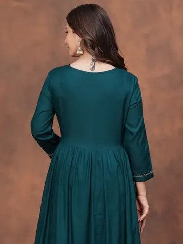 Tarani green silk dress back view highlighting graceful flare